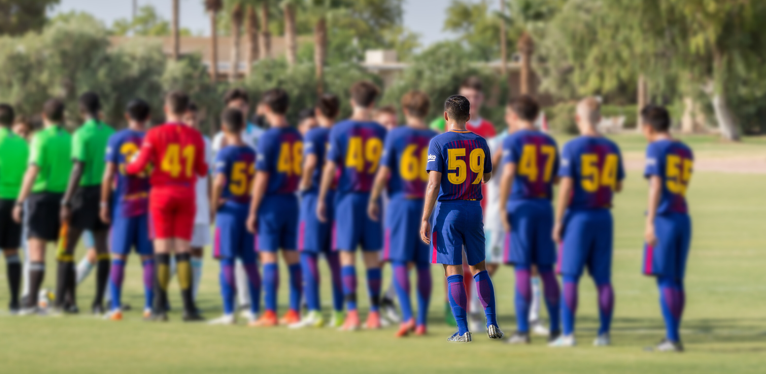 (Barça Academy Player Insider) Barça Academy soccer player, Jose Olmos, and teammates shaking opponents hand after a game at Grande Sports World