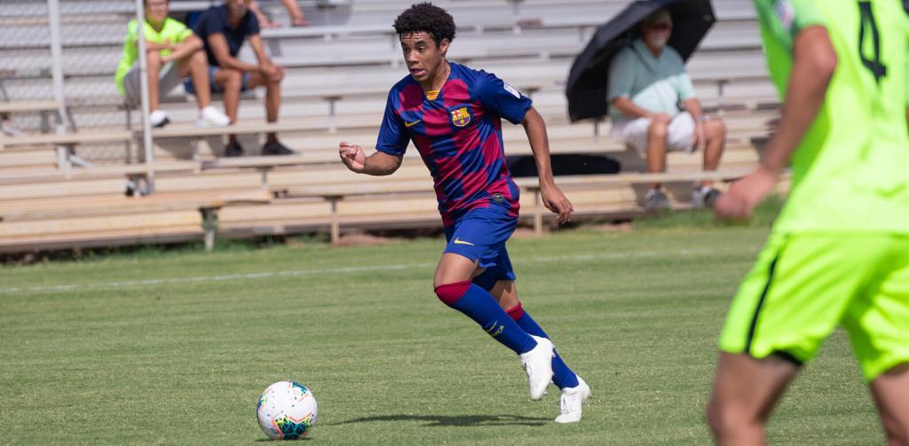 Mile Lyons Driving the ball up field for Barca Residency Academy