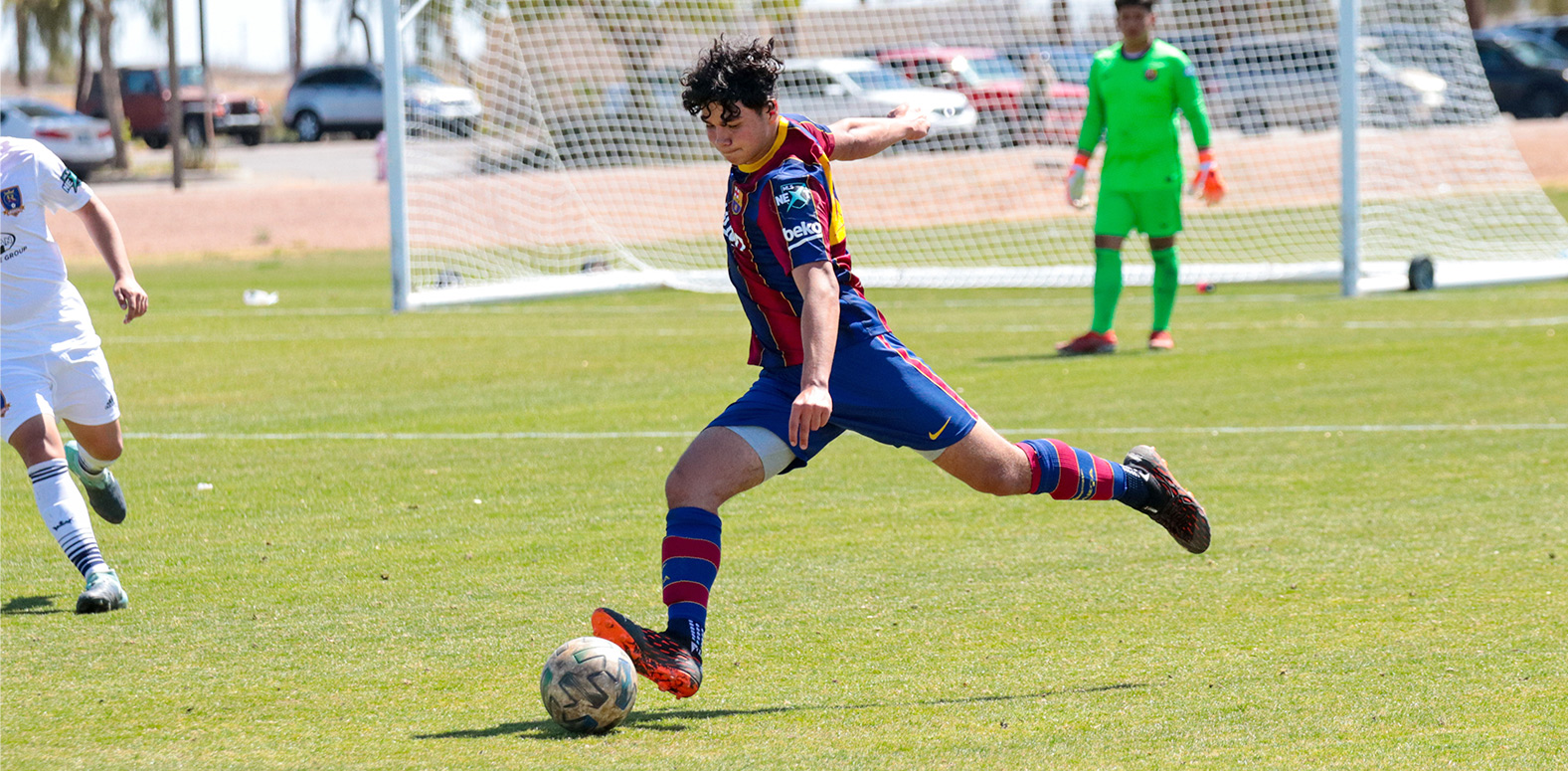 Barca Residency Academy's Ryan Firestone striking the ball in a match vs. RSL-AZ