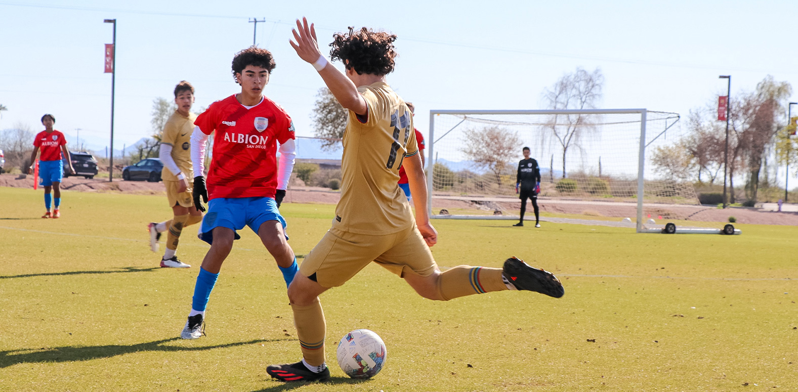 Barca Residency Academy player striking ball vs. Albion SC San Diego